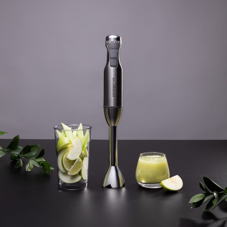 Блендер Polaris стоит на столе вместе со стаканом с фруктовым коктейлем